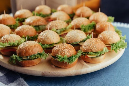 Hamburger on wood table. Home made burger. Fastfood meal. Pub burger. Delicious Hamburger. Gourmet hamburger.