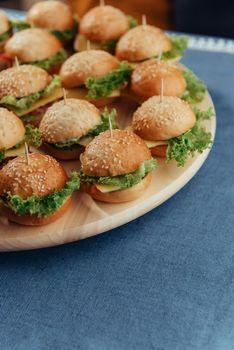 Hamburger on wood table. Home made burger. Fastfood meal. Pub burger. Delicious Hamburger. Gourmet hamburger.