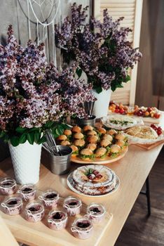 Canapes and drinks a desserts on the buffet table.