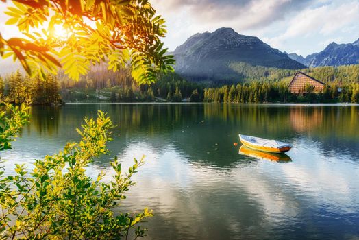 Boat on the dock surrounded by mountains at sunset. Fantastic Shtrepske Pleso High Tatras. Slovakia, Europe