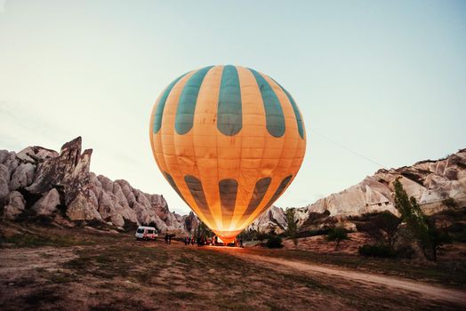 Cappadocia, Turkey. The first crew of flame and heat for inflating the balloon before launch. Balloon is one of the most famous of that trip will have to do in Cappadocia