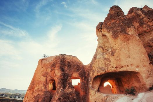 Unique geological formations in valley in Cappadocia, Central Anatolia, Turkey. Cappadocian Region with its valley and hills located between the volcanic mountains.