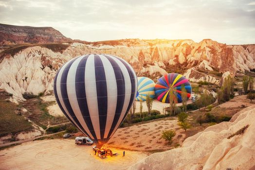 Cappadocia, Turkey. The first crew of flame and heat for inflating the balloon before launch. Balloon is one of the most famous of that trip will have to do in Cappadocia