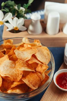 Potato chips with sauce on the table. Homemade sauces.