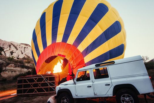 Cappadocia, Turkey. The first crew of flame and heat for inflating the balloon before launch. Balloon is one of the most famous of that trip will have to do in Cappadocia