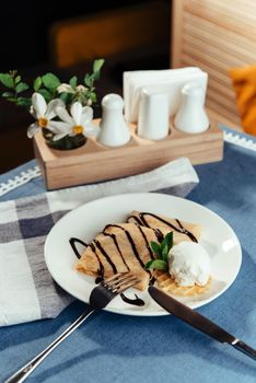 Pancakes with ice cream and chocolate sauce.