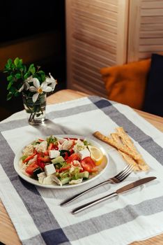 Greek salad with fresh vegetables, feta cheese and black olives.