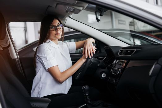 portrait of young beautiful woman sitting in the car.