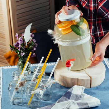 party drink station with small bottles and homemade lemonade.