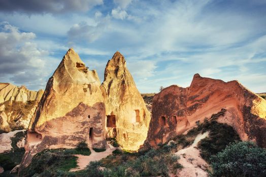 Unique geological formations in valley in Cappadocia, Central Anatolia, Turkey. Cappadocian Region with its valley and hills located between the volcanic mountains.