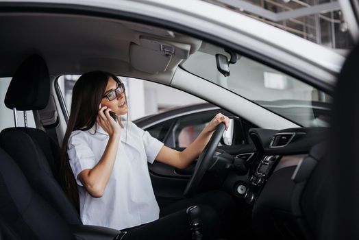 Businesswoman talking on the phone in the car