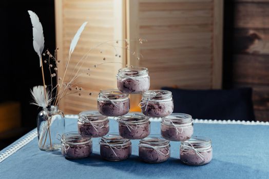 Blueberry dessert and fresh berries in a glass jar.
