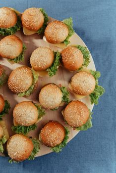 Hamburger on wood table. Home made burger. Fastfood meal. Pub burger. Delicious Hamburger. Gourmet hamburger.