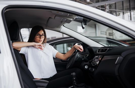 portrait of young beautiful woman sitting in the car.