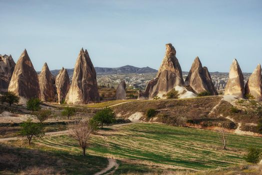Review unique geological formations in Cappadocia, Turkey. Kappadokiets region, with its valleys, gorges, hills, located between the volcanic mountains in Goreme National Park.