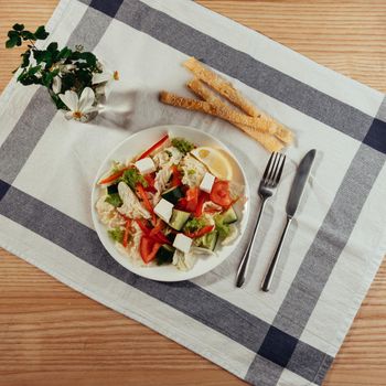 Greek salad with fresh vegetables, feta cheese and black olives.