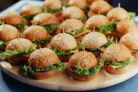 Hamburger on wood table. Home made burger. Fastfood meal. Pub burger. Delicious Hamburger. Gourmet hamburger.