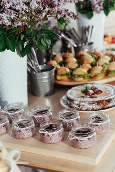 Canapes and drinks a desserts on the buffet table.
