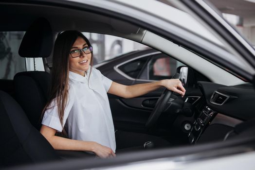 portrait of young beautiful woman sitting in the car.