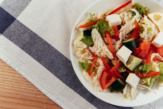 Greek salad with fresh vegetables, feta cheese and black olives.
