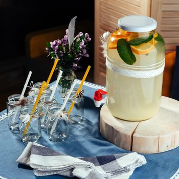 party drink station with small bottles and homemade lemonade.