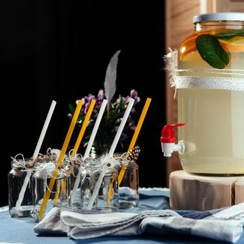 party drink station with small bottles and homemade lemonade.