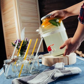 party drink station with small bottles and homemade lemonade.
