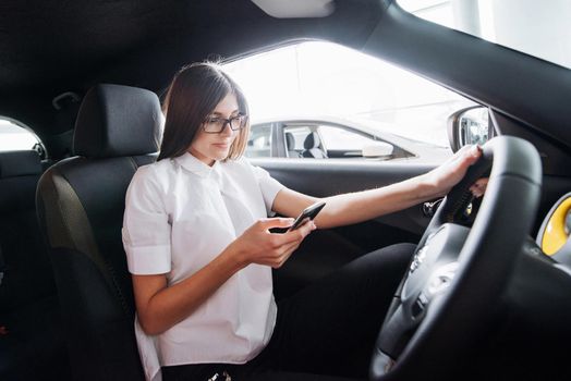 Businesswoman talking on the phone in the car.