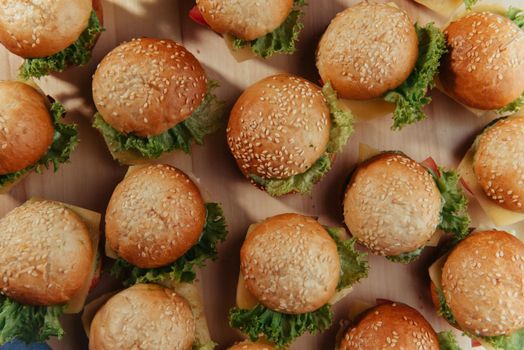 Hamburger on wood table. Home made burger. Fastfood meal. Pub burger. Delicious Hamburger. Gourmet hamburger.