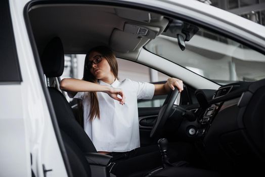 portrait of young beautiful woman sitting in the car.