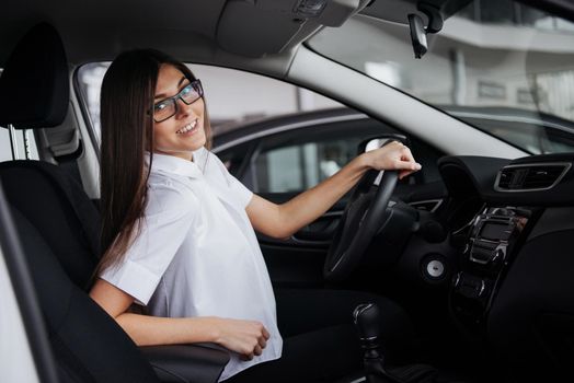 portrait of young beautiful woman sitting in the car.