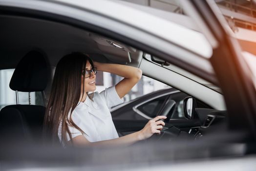 portrait of young beautiful woman sitting in the car.