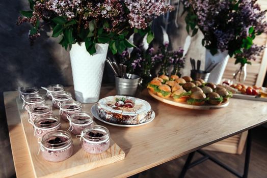 Canapes and drinks a desserts on the buffet table.
