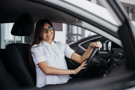 portrait of young beautiful woman sitting in the car.