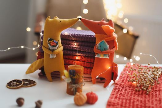 Autumn cozy still life with toy, candles and leaves. Cozy fall house decor, Thankgiving concept. Flat lay, hygge style.