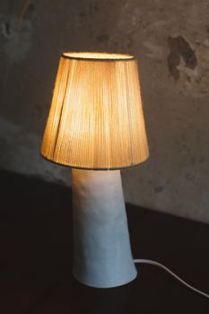 Stylish burning night lamp on table indoors. Light electric for interior home