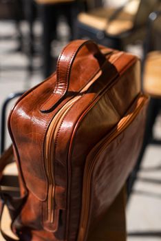 Orange leather backpack. Street photo.