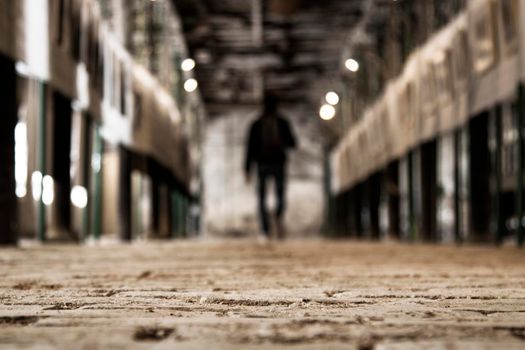 Corridor and a blurry person walking in a photography exposition in an old factory in Igualada