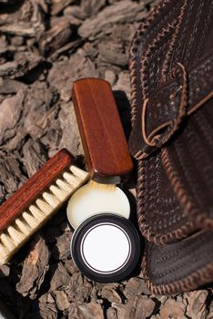 Wax and brush, leather maintenance concept. old genuine leather bag on a background. .