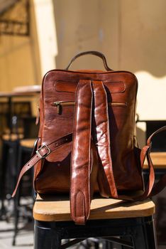 Orange leather backpack. Street photo.