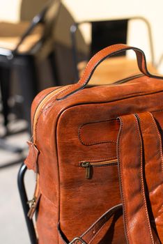 Orange leather backpack. Street photo.