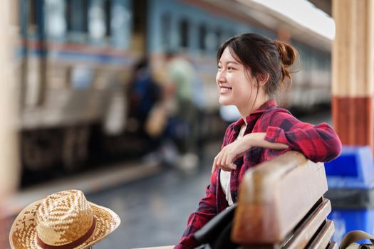 Beautiful traveler with backpack go to summer trip by train. Travel concept