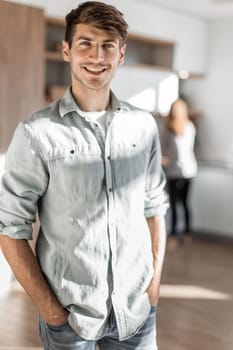 handsome young man standing in his kitchen. photo with copy space