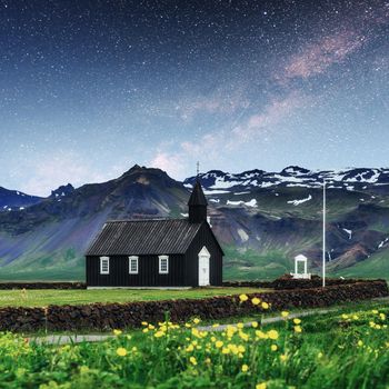 Mountain View Iceland. Fantastic starry sky and the milky way. Beautiful black wooden church in Budir.