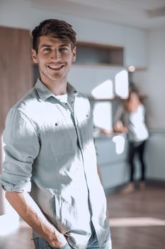 handsome young man standing in his kitchen. photo with copy space