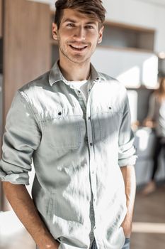 handsome young man standing in his kitchen. photo with copy space