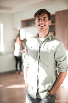 handsome young man standing in his kitchen. photo with copy space