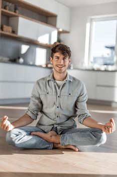 smiling young man standing in front of his colleagues. photo with copy space