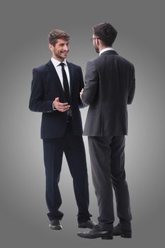 in full growth. two young businessmen discussing something. isolated on white background