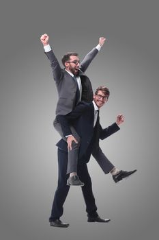 smiling businessman sitting on the back of his colleague . isolated on white background.